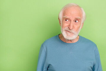 Photo of sad old beard man look empty space wear blue pullover isolated on green color background