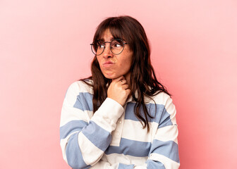 Young Argentinian woman isolated on pink background suffers pain in throat due a virus or infection.
