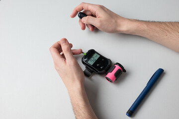A man with diabetes is tested with a glucometer to find out his blood sugar level.