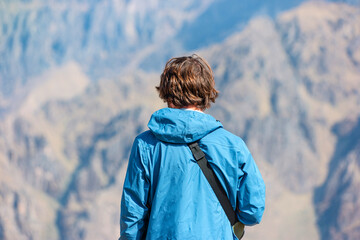 A tourist looks at the world's deepest canyon Colca in Peru