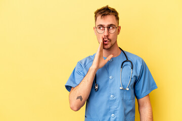 Young nurse caucasian man isolated on yellow background is saying a secret hot braking news and...