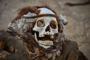 skull of a mummy in Peru with rope and hair