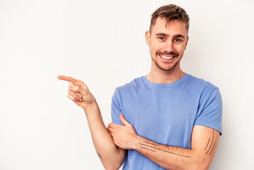 Young caucasian man isolated on pink background touching back of head, thinking and making a choice.