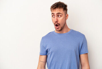 Young caucasian man isolated on pink background excited keeping ok gesture on eye.