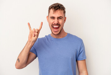 Fototapeta premium Young caucasian man isolated on white background pointing with forefingers to a copy space, expressing excitement and desire.