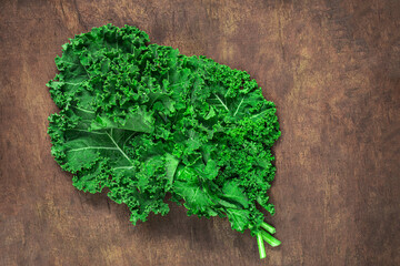 Kale leaf salad on wooden table. Fresh Kale closeup. Flat lay. Food  vegan concept. Copyspace.