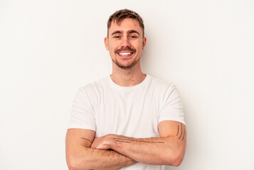 Young caucasian man isolated on white background trying to listening a gossip.