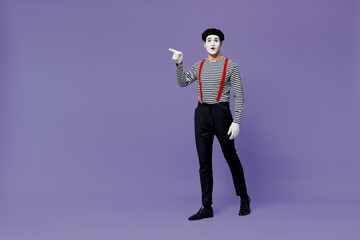 Full size amazed young mime man with white face mask wears striped shirt beret point finger aside...