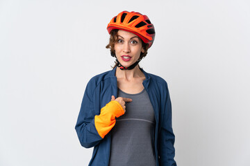 Young cyclist woman isolated on white background with surprise facial expression