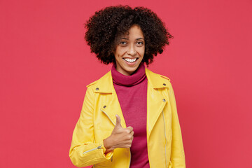 Obraz na płótnie Canvas Charming bright happy young curly black latin woman 20s years old wears yellow jacket showing thumb up like gesture isolated on plain red background studio portrait. People emotions lifestyle concept.