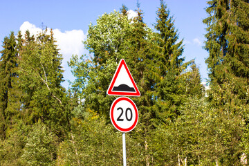 Two road signs for motorists warning about pedestrians and cyclists - speed limit to 20 kmh per...