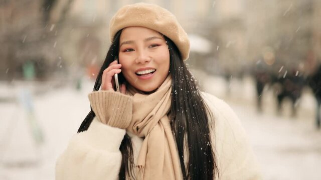 Portrait of attractive young asian woman using mobile phone. Positive woman with smartphone have a phone call. High quality 4k footage