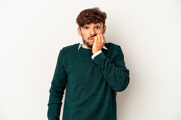 Young mixed race man isolated on grey background biting fingernails, nervous and very anxious.