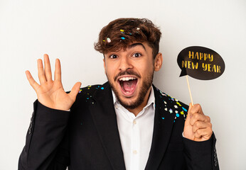 Young mixed race man holding new year props isolated on white background