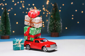 A red car on the background of a forest carries Christmas gifts