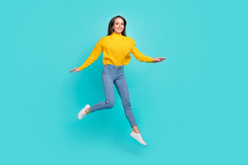Fototapeta na wymiar Full length body size view of attractive cheerful girl jumping going having fun isolated over bright teal turquoise color background