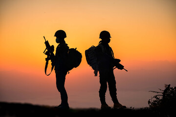 Fototapeta na wymiar Soldiers in uniform patrolling outdoors.