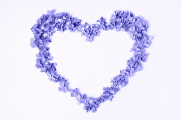 Heart of lilac flowers. Trendy color of the year 2022. Very peri. Flat lay, top view, copy space