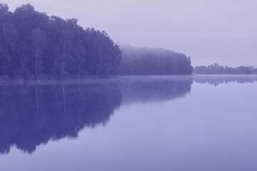 toned landscape with beautiful summer lake in morning, color of year 2022
