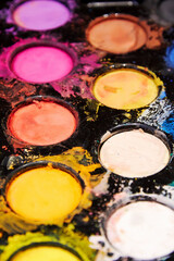 Vertical pallet with mixed bright paints. Splatters and messy colors