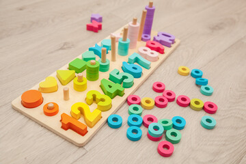 Children's colorful wooden educational toy with numbers, figures and rings.