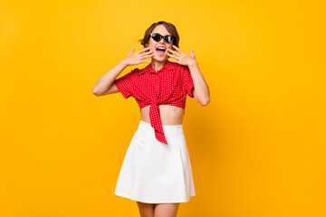 Photo of young pretty lovely happy smiling cheerful girl in sunglasses see big sale discount isolated on yellow color background