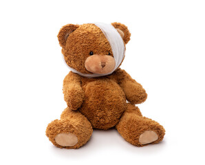 medicine, healthcare and childhood concept - teddy bear toy with bandaged head having toothache on white background
