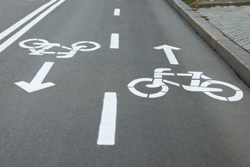 Fototapeta premium Two way bicycle lane with white signs on asphalt