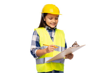 Fototapeta premium building, construction and profession concept - smiling little girl in protective helmet and safety vest with clipboard and pencil over white background