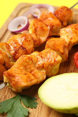 Concept of tasty food with chicken shashlik on yellow background