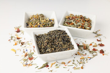 Concept of cooking tea with different types of tea on white background