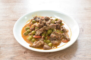 spicy boiled slice beef with eggplant in coconut milk red curry soup on dish