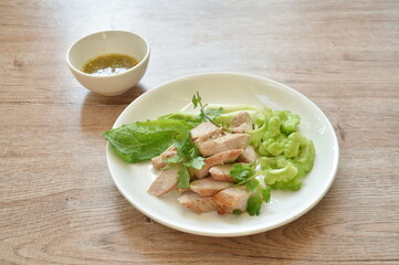 roasted pork slice dressing with lime garlic and chili sauce salad on plate