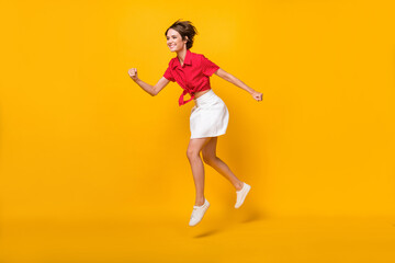 Fototapeta na wymiar Full size profile photo of optimistic nice brunette lady run wear shirt skirt isolated on yellow background