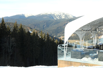 Terrace of cafe on ski slope against mountains