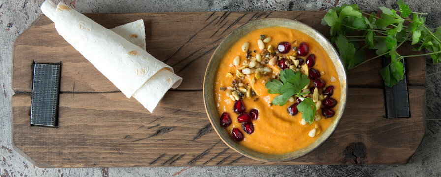 a bowl of pumpkin hummus on the table