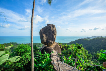 Background of evening natural light on high mountains overlooking the sea, coconut palms,hillside villas and large rocks (overlap stone) on Koh Samui,Surat Thani Province of Thailand