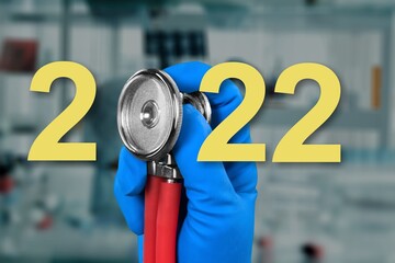 Doctor's stethoscope with gold 2022 on the desk.