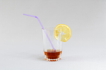 Glass with drink on gray background
