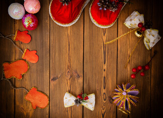 Christmas decorations on a brown wooden background. Christmas tree balls and red decorations. Copy space for text