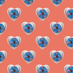 Seamless pattern with a donut in a plate in the shape of a heart