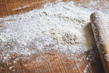 flour and rolling pin on wooden table