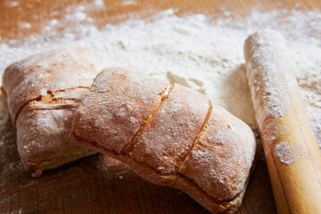 Fresh bread, flour and rolling pin 