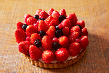 Strawberry blueberry cake on wooden table