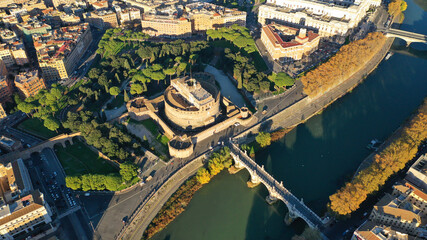 Aerial drone view of iconic Castel Sant'Angelo (castle of Holy Angel) and Ponte or bridge Sant'Angelo with statues in river of Tiber next to famous Vatican, Rome, Italy