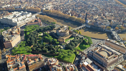 Fototapeta premium Aerial drone view of iconic Castel Sant'Angelo (castle of Holy Angel) and Ponte or bridge Sant'Angelo with statues in river of Tiber next to famous Vatican, Rome, Italy