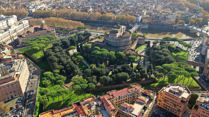 Aerial drone view of iconic Castel Sant'Angelo (castle of Holy Angel) and Ponte or bridge Sant'Angelo with statues in river of Tiber next to famous Vatican, Rome, Italy