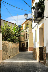 Fototapeta na wymiar Narrow street and typical facades of Beniarda village