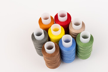 Color sewing threads isolated on white background. Different colors.Bright bobbin thread.