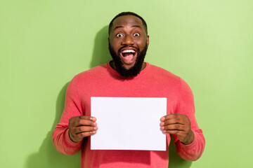 Photo of excited crazy funky person hands hold empty space blank isolated on green color background